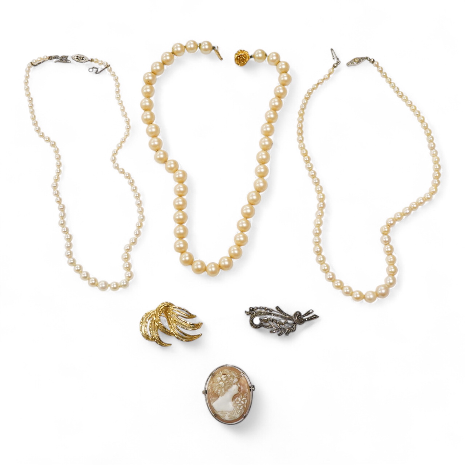 Two single strand graduated cultured pearl necklaces, one with a single stone rose cut diamond set 9ct white metal clasp, 42cm, together with a simulated pearl necklace and three assorted costume brooches.